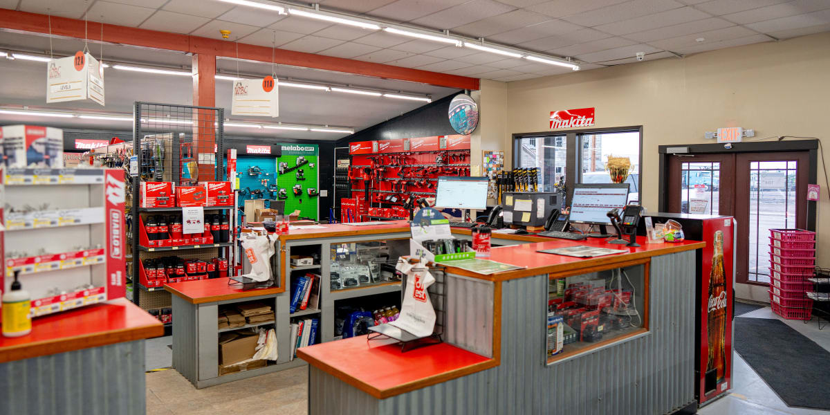 Interior view of a Western Building Center store showing the tools department with prominent red tool displays and Makita sig