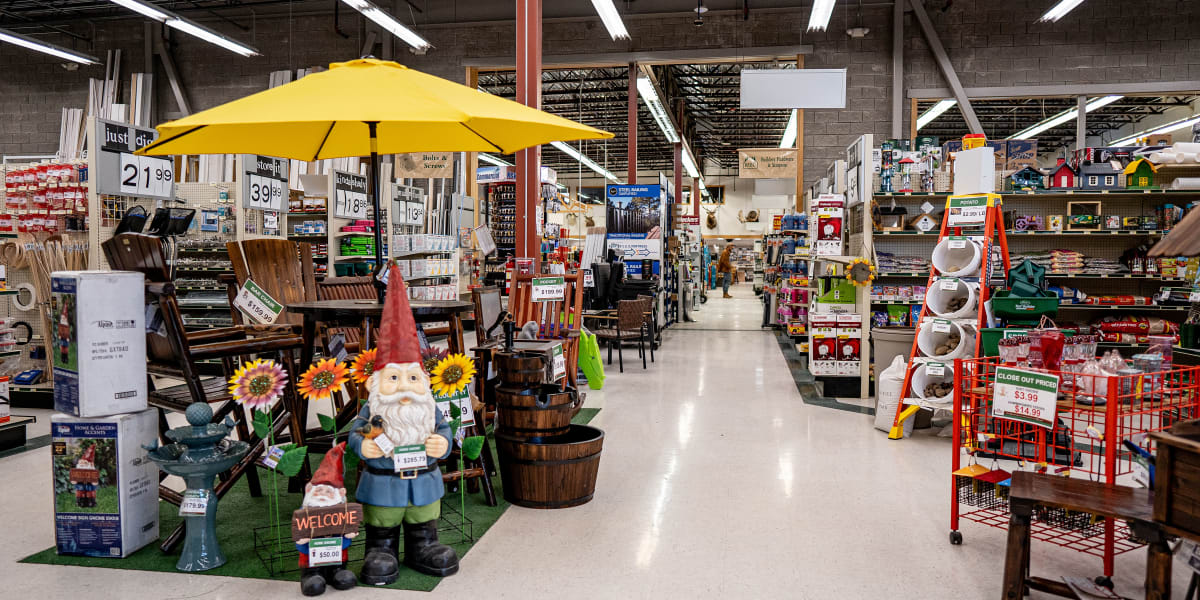 Interior view of a Western Building Center store showing multiple departments and aisles with outdoor/garden merchandise prom