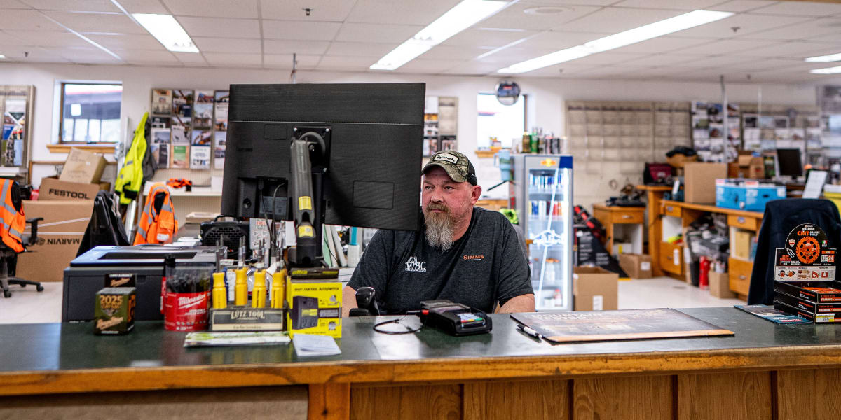 Interior view of a Western Building Center store showing the customer service counter area with an employee working at a comp