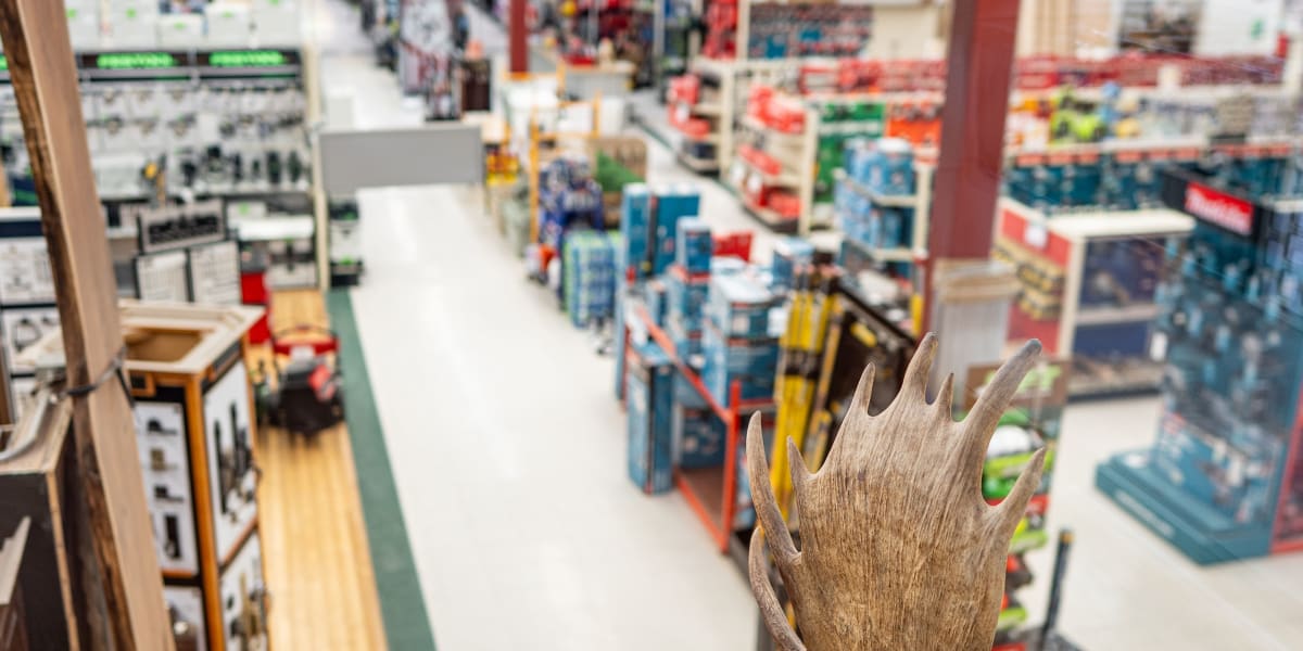 Interior view of a Western Building Center store showing multiple aisles with shelving units containing various building supp
