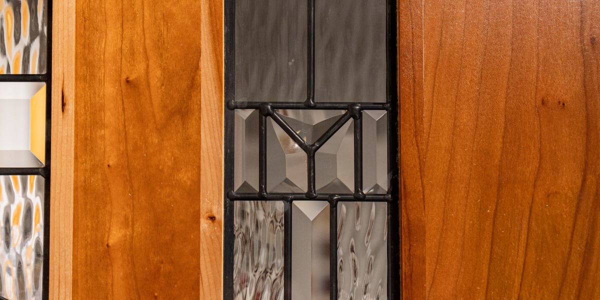 Close-up detail shot of decorative glass panels in a wooden door or cabinet frame