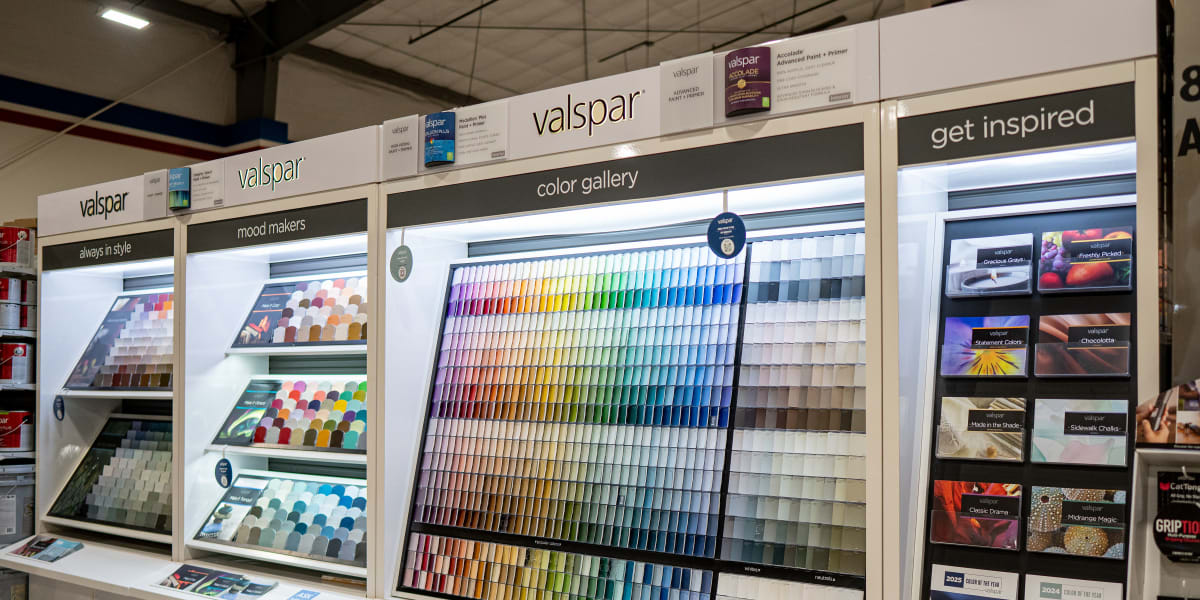 Interior view of the paint department showing an extensive Valspar paint display with organized sections including 'mood make