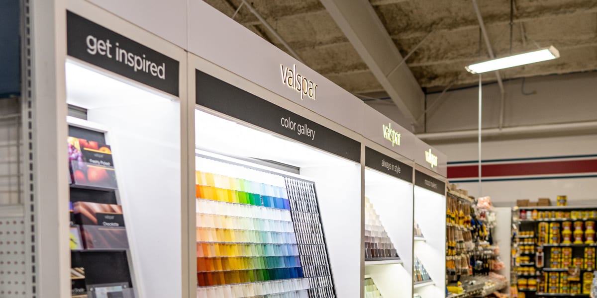 Paint department display featuring Valspar paint color gallery with an extensive array of color swatches arranged in rainbow