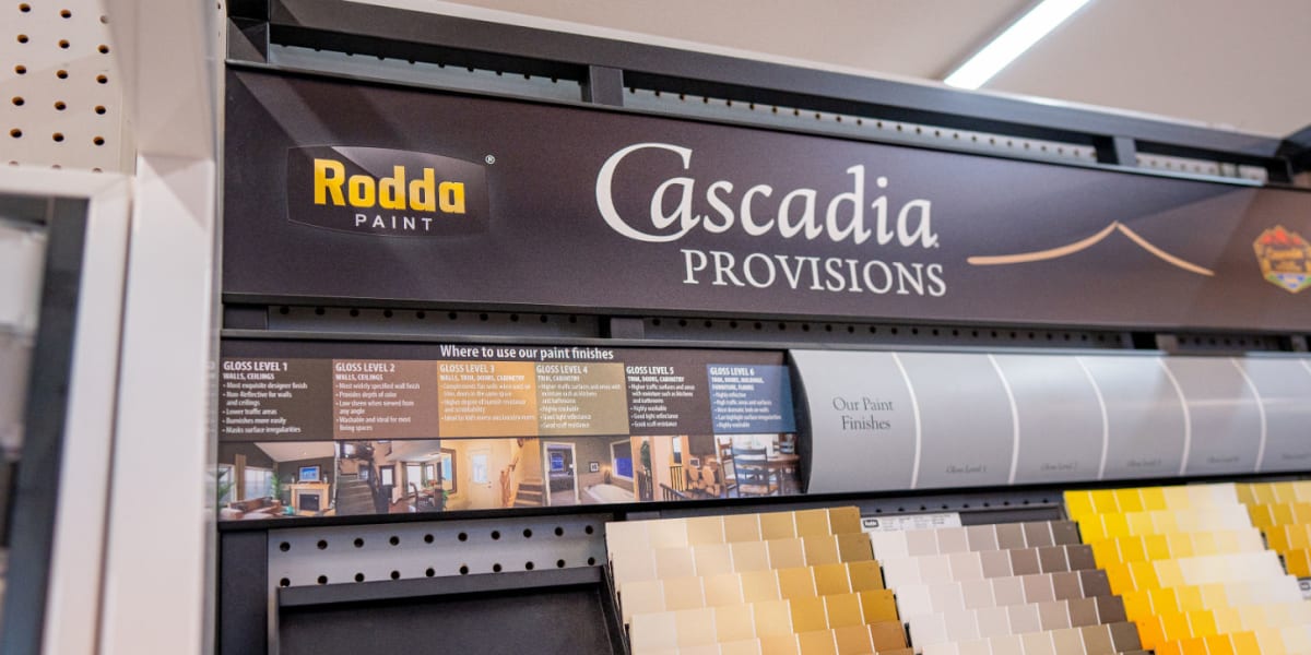 Paint department display showing Rodda Paint's Cascadia Provisions collection with informational signage about paint finishes