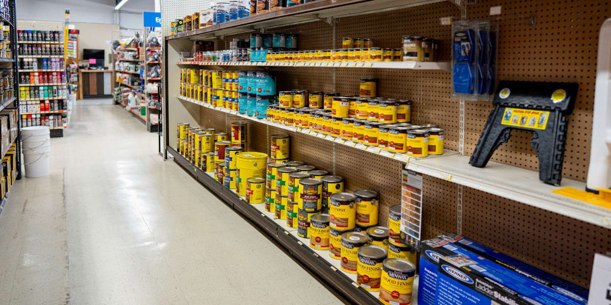 Interior view of the paint department showing extensive shelving with wood stain and finish products