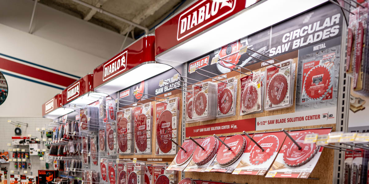A comprehensive display of Diablo circular saw blades in the tools department, featuring multiple shelves and pegboard displa