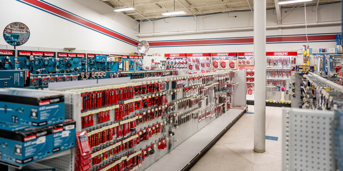 Interior view of the tools department showing extensive pegboard displays of hand tools and hardware items