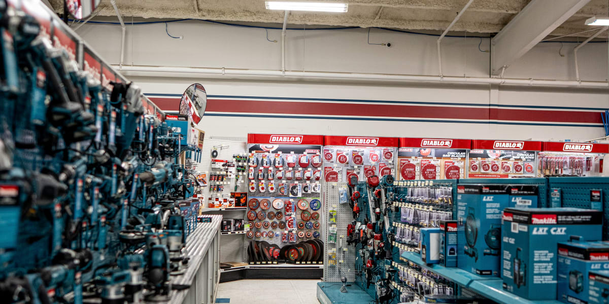 Interior view of the tools department showing well-organized aisles with extensive tool displays