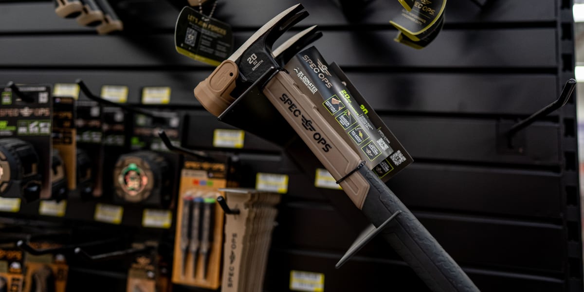 Close-up product display showing STECCO PE cordless power tools hanging on retail hooks in a store setting