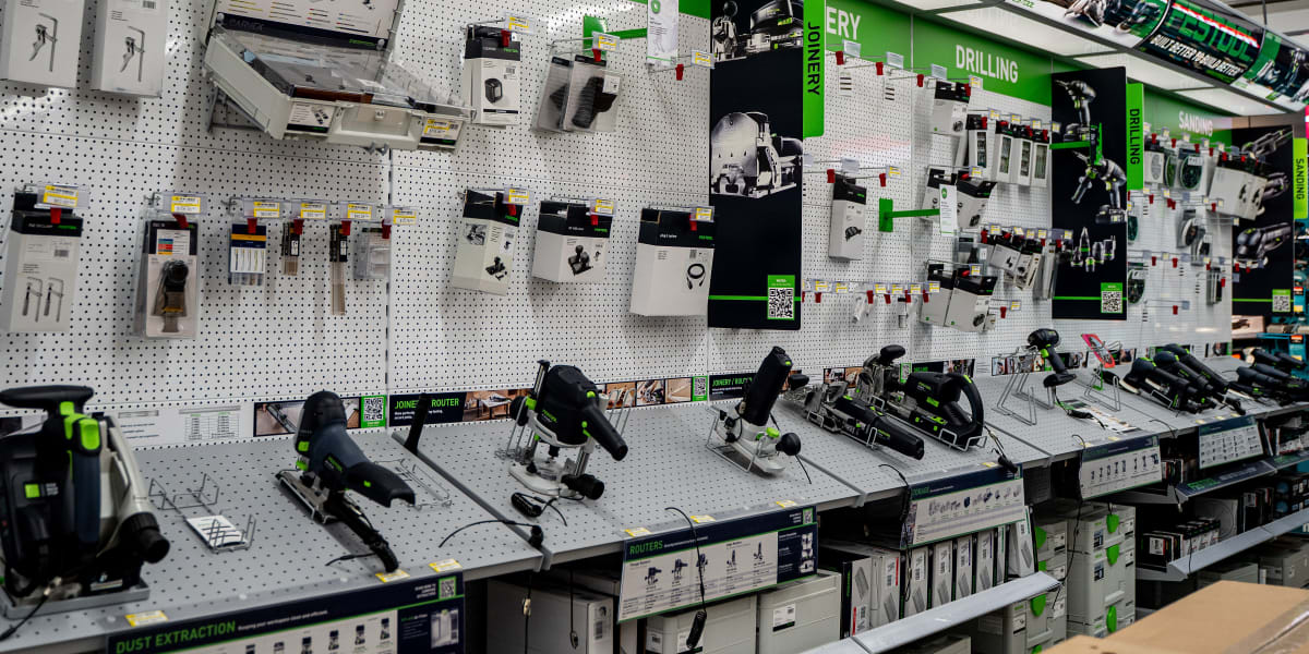This image shows a comprehensive Festool power tool display section within the store, featuring organized wall displays of ro