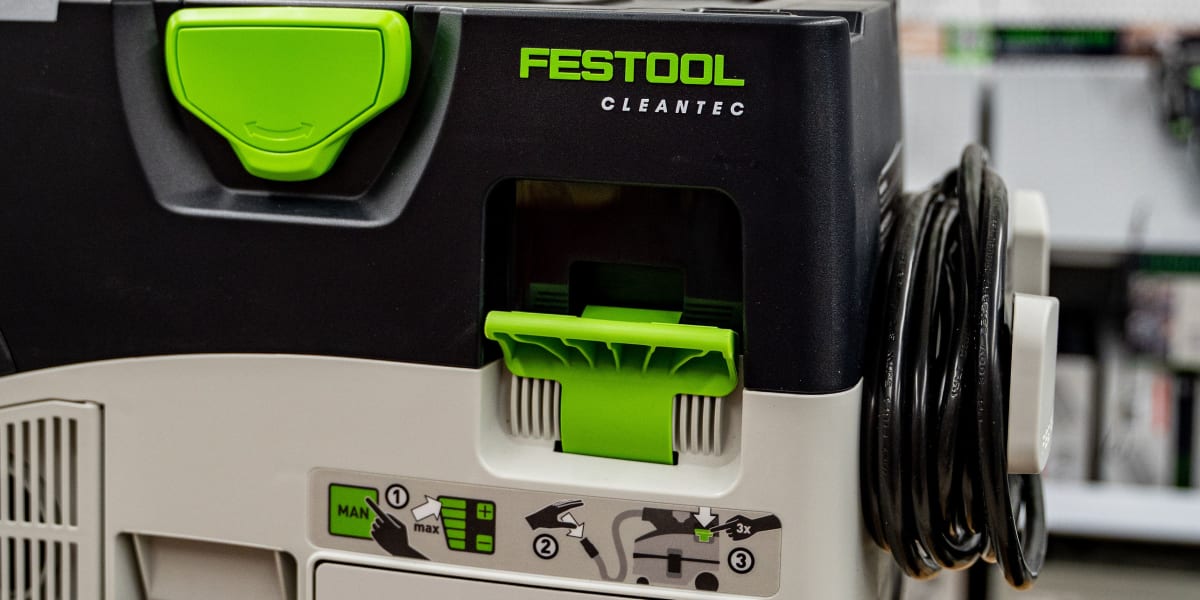 A Festool Cleantec dust extraction system is prominently displayed in the foreground, featuring the characteristic black and
