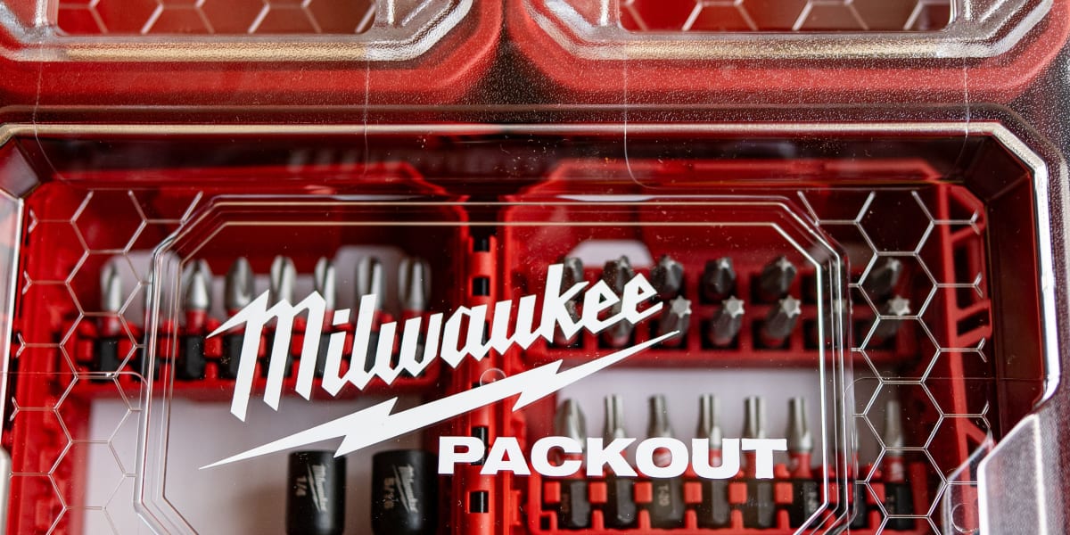Close-up view of a red Milwaukee PACKOUT modular storage system showing multiple compartments with clear lids and hexagonal i