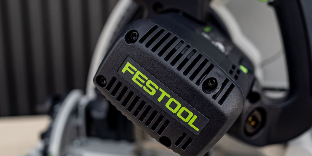 Close-up product photo of a Festool cordless circular saw with black and green color scheme, showing the motor housing with p