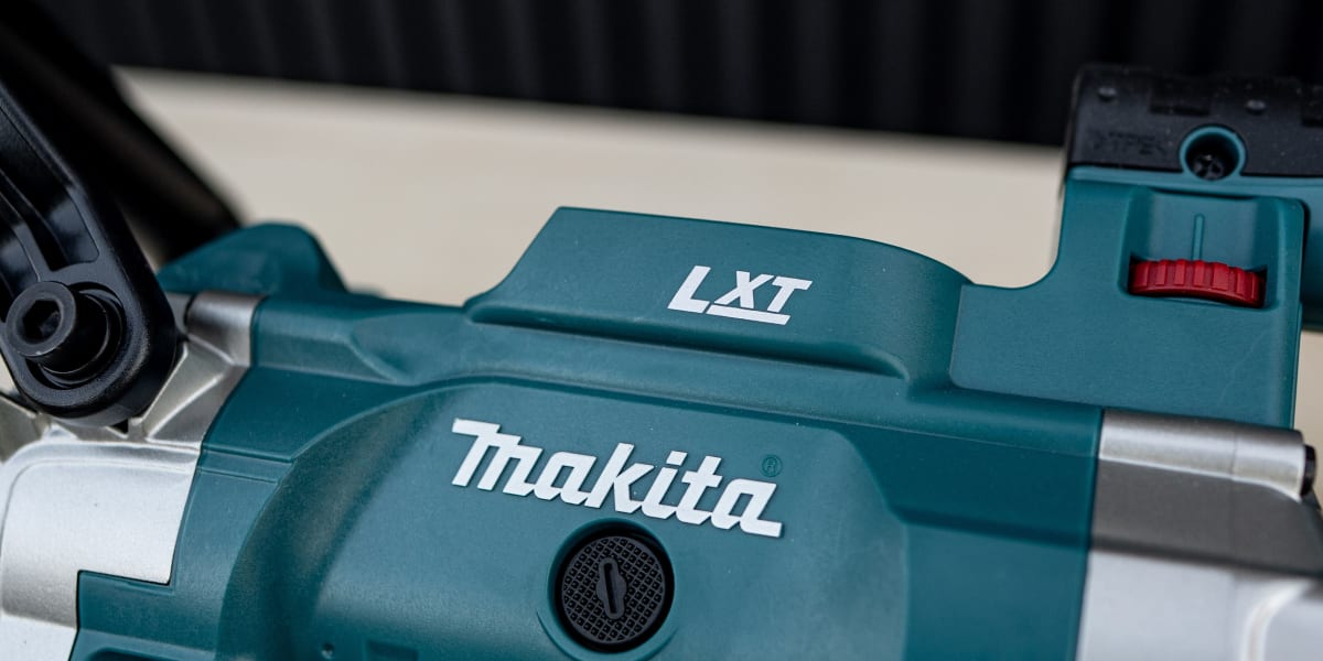 Close-up detail shot of a Makita LXT cordless power tool, showing the teal-colored tool body with prominent Makita branding a