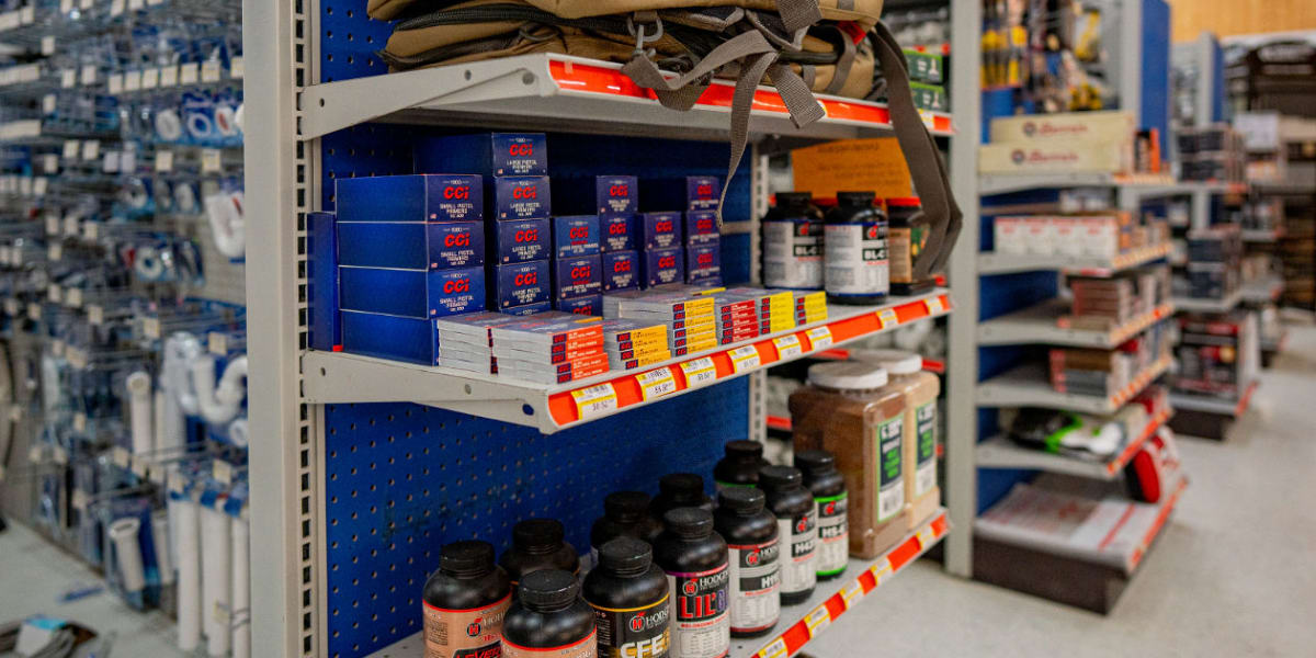 Interior store aisle showing multiple shelves stocked with various tools and hardware supplies