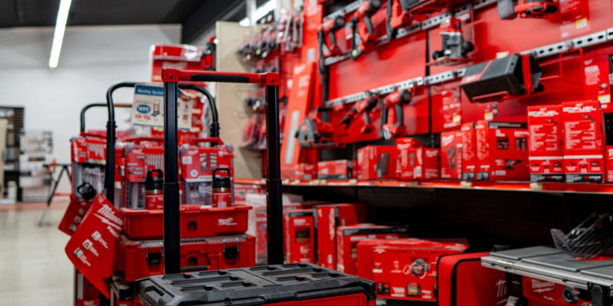 Interior view of a store's tool department showing an extensive display of Milwaukee PACKOUT modular storage systems