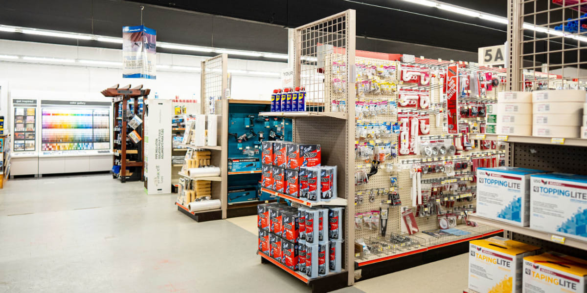 Interior view of the tools and hardware department showing organized pegboard displays with various hardware items, small too