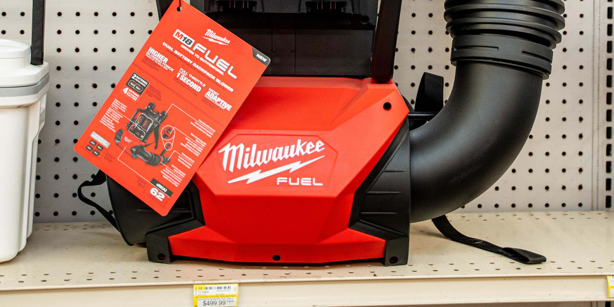 A Milwaukee M18 FUEL cordless wet/dry vacuum displayed on a store shelf with its product packaging visible