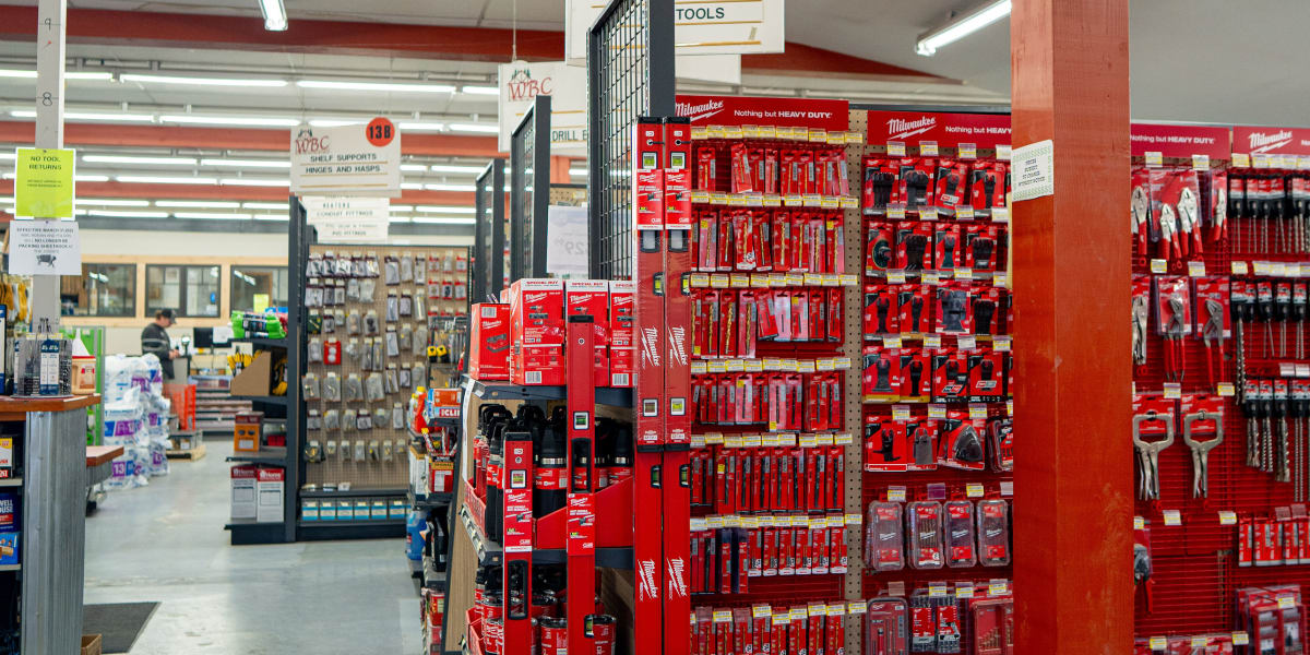 Interior view of a Western Building Center store showing the power tools aisle (section 10B) with extensive displays of red M