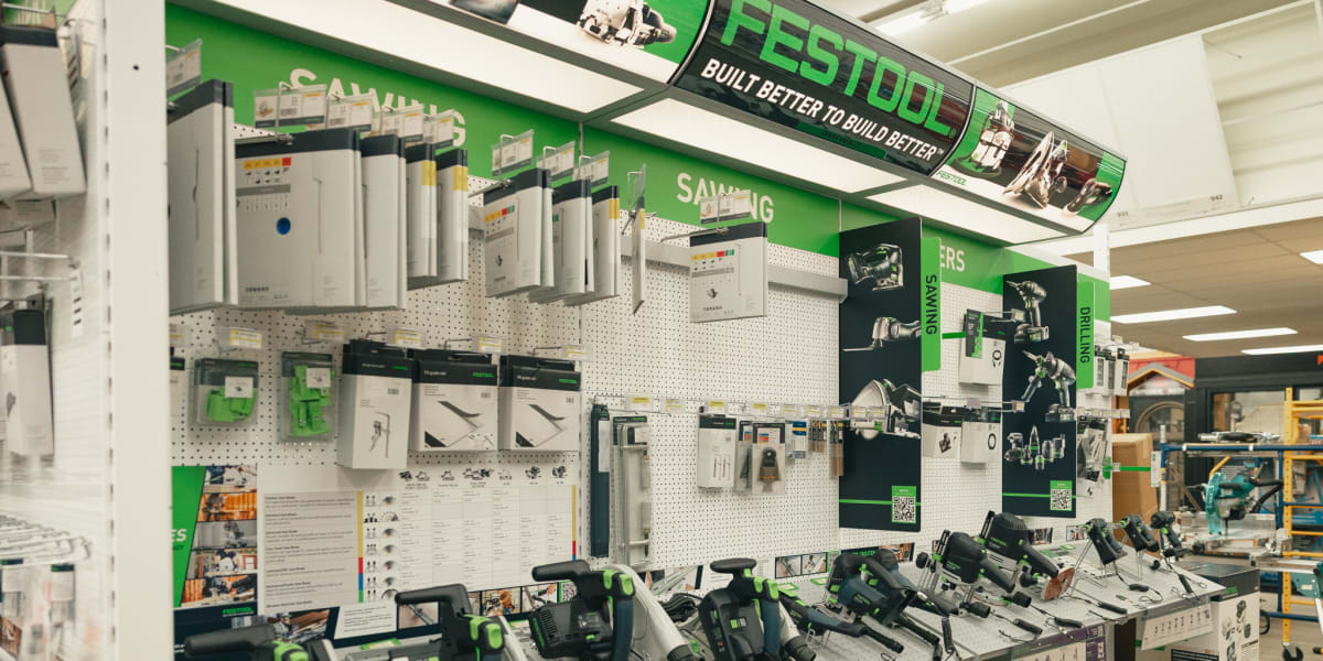 Interior view of a tool department showing a prominent Festool display with multiple track saws and drilling tools arranged o