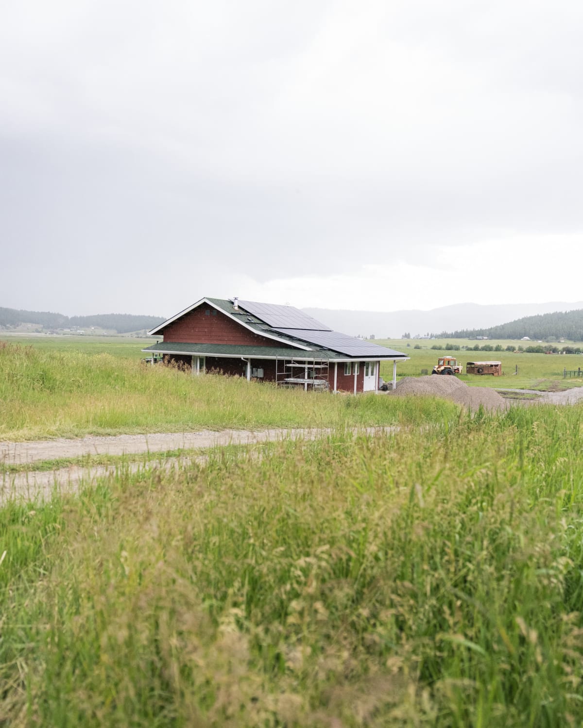Solar array being installed on a red Montana farmhouse