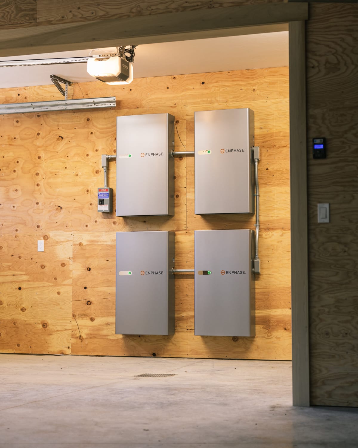 Four wall-mounted Enphase battery cabinets