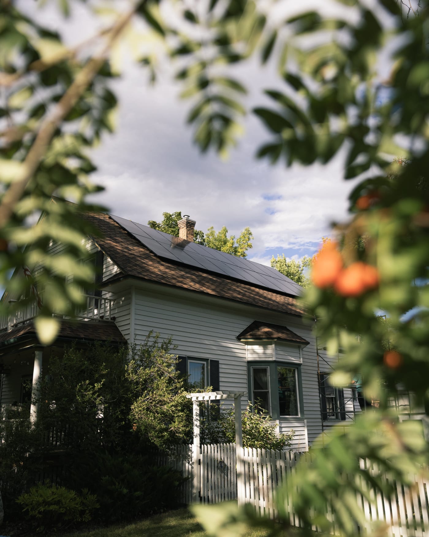 White Montana farmhouse with a rooftop solar array