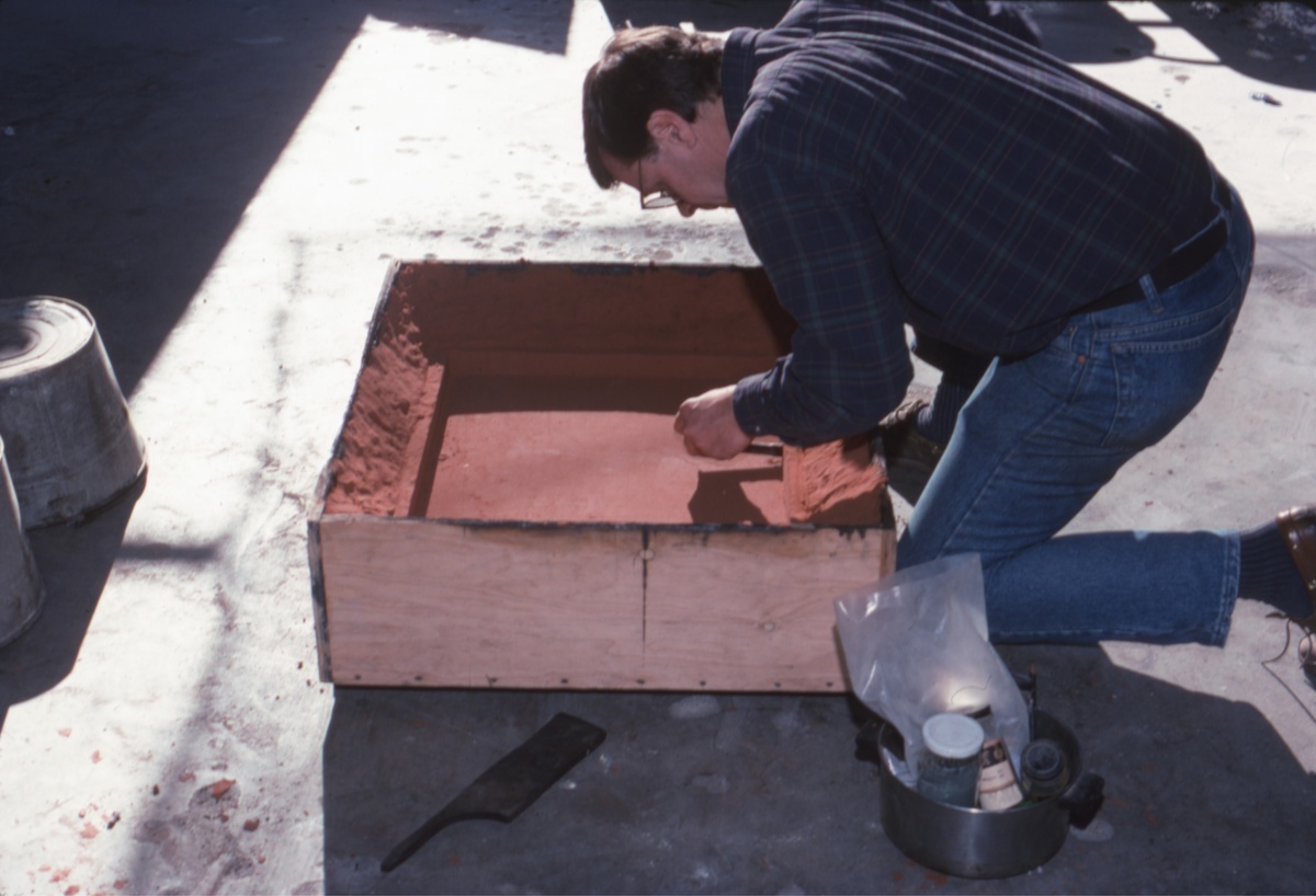 Preparing the sand mold for casting