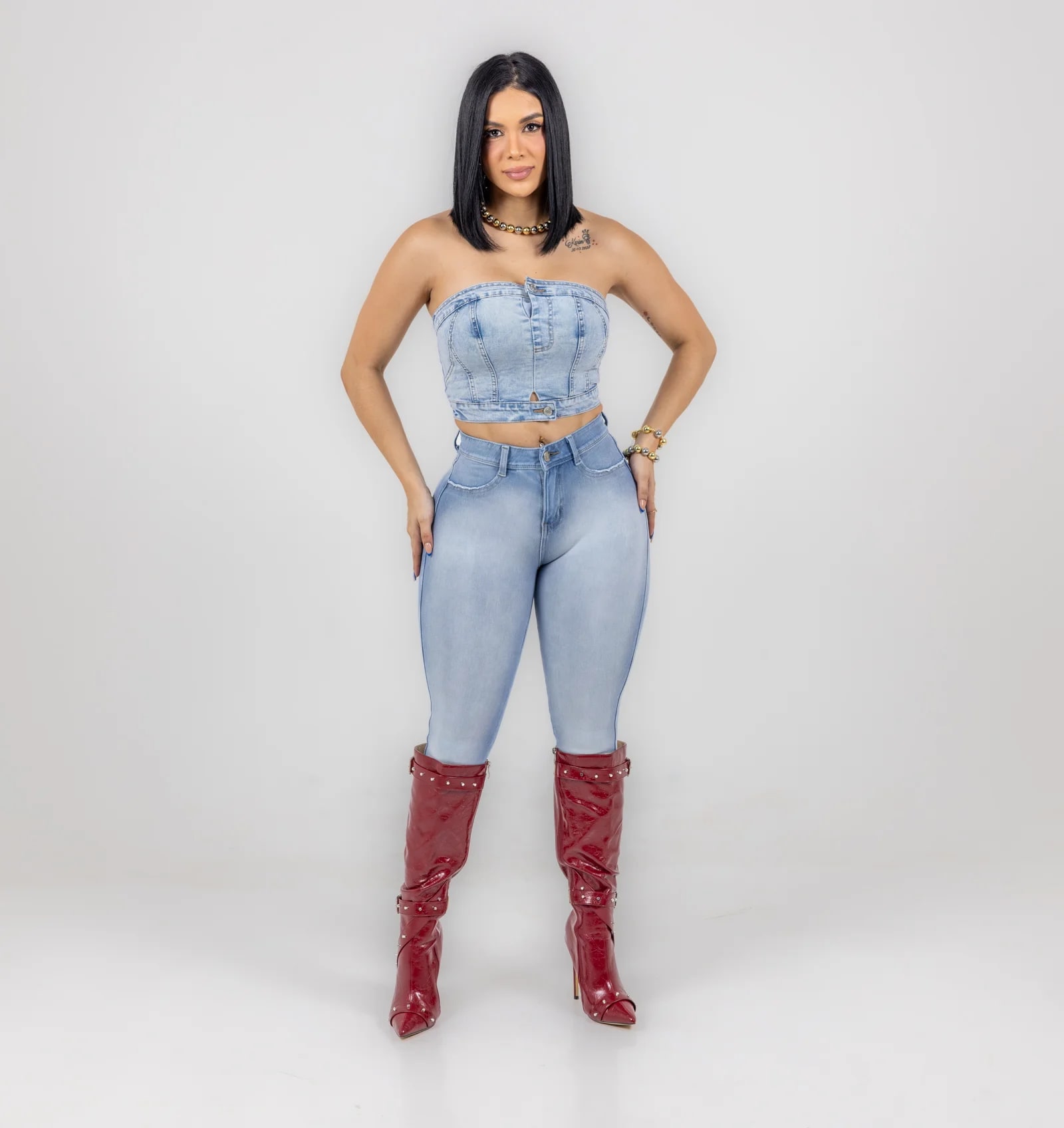Lipo Jeans — strapless denim top with skinny jeans and tall red boots, front view