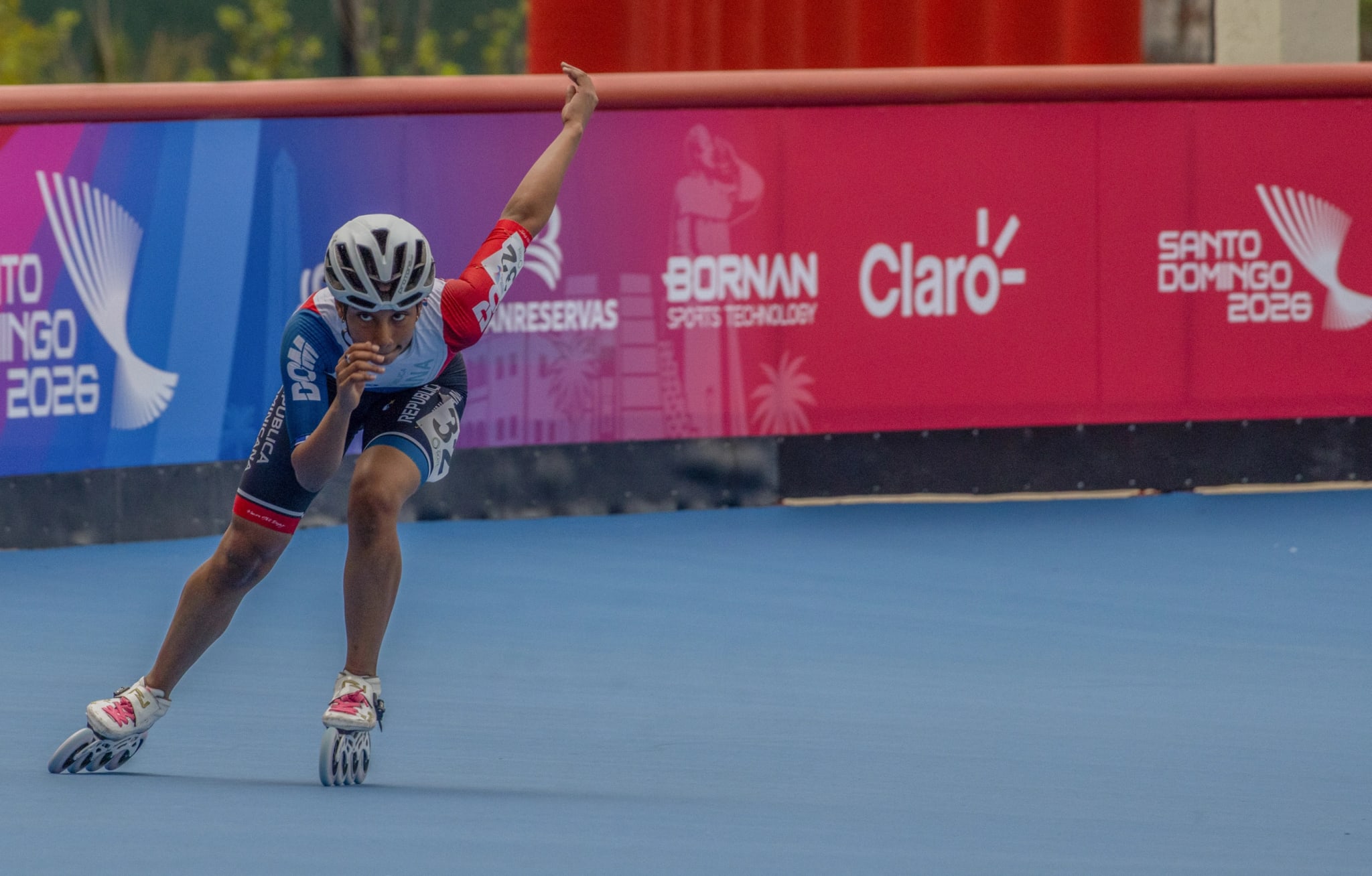 Speed skater at a low angle mid-turn during competition