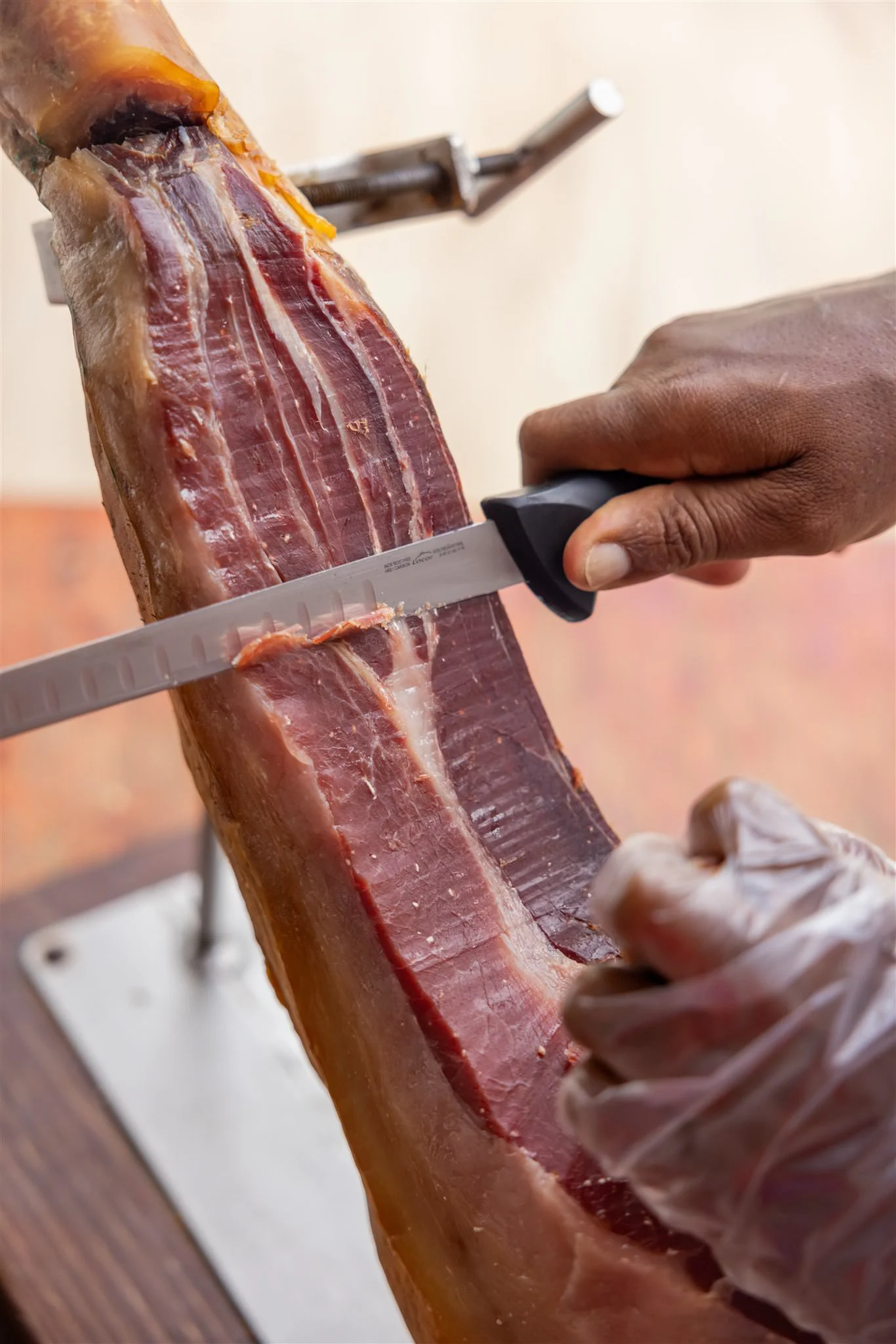 Hand-carving Serrano ham tableside at a restaurant