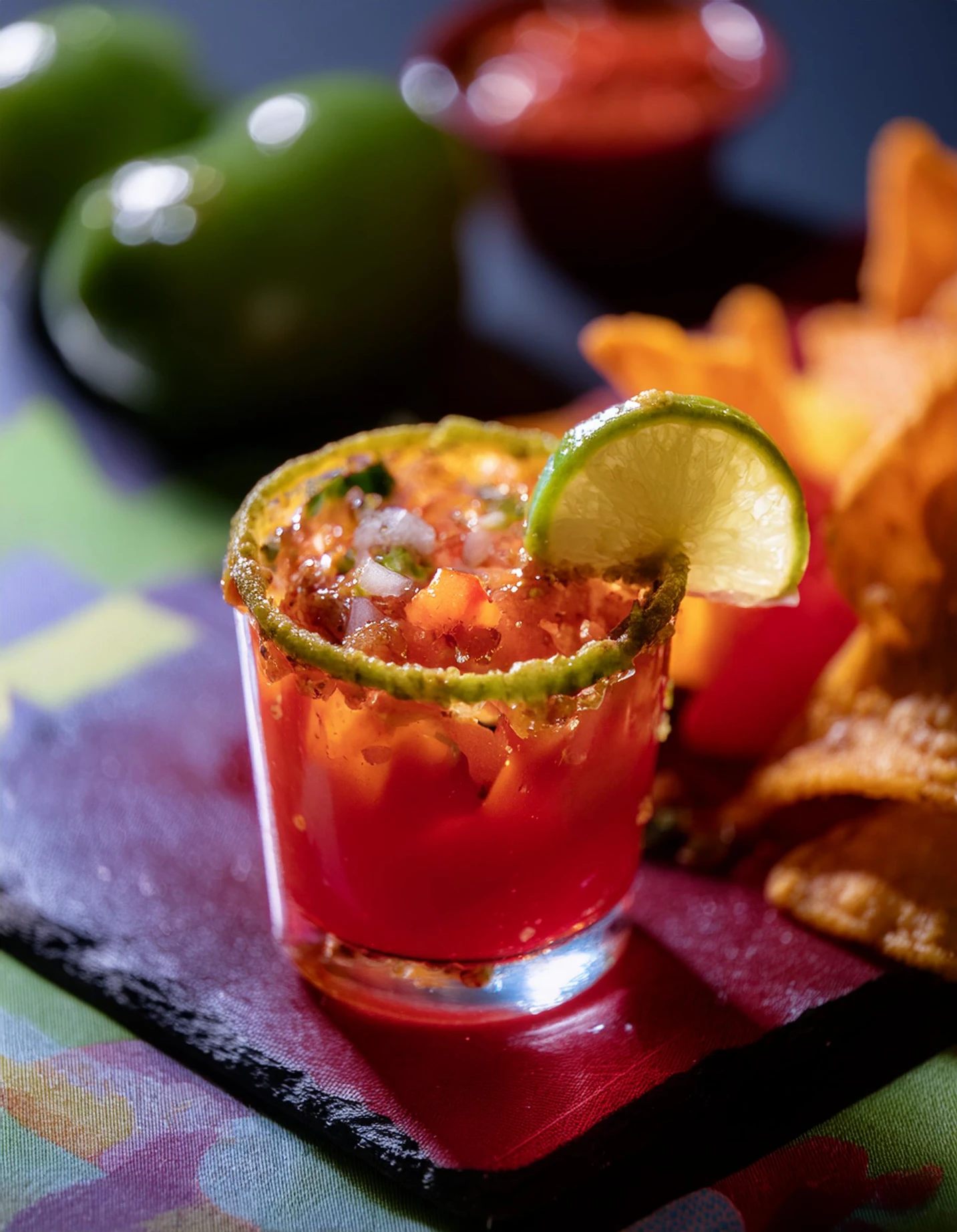 Michelada beer cocktail with a salted rim and lime, served with tortilla chips