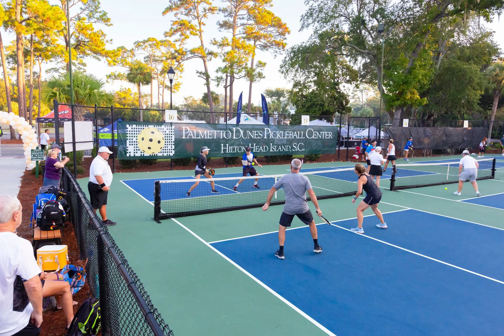 group of teams playing pickleball at Palmetto Dunes Pickleball center with spectators watching
