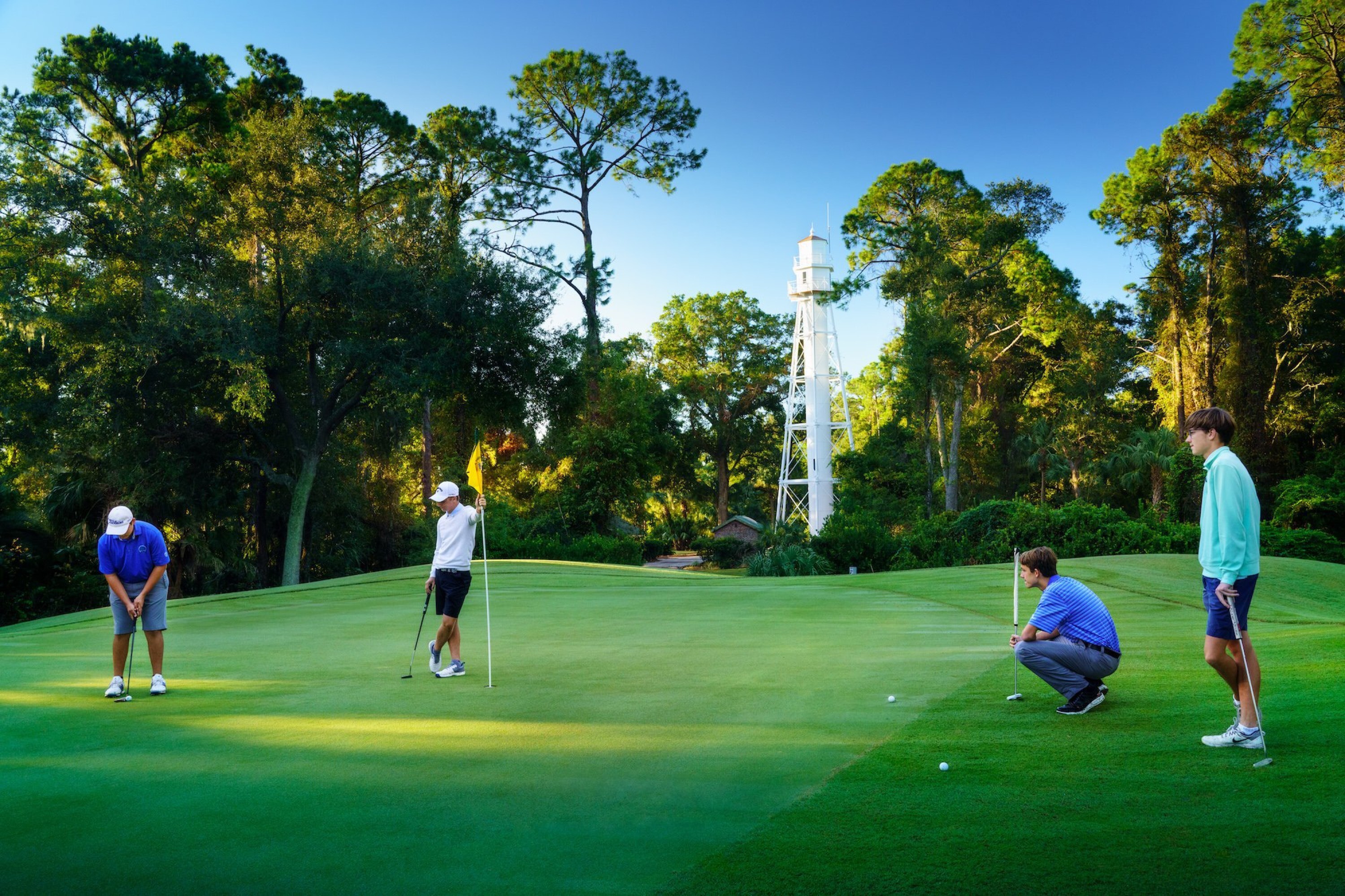 Golfers on the Arthur Hills Course with Lighthouse in the background