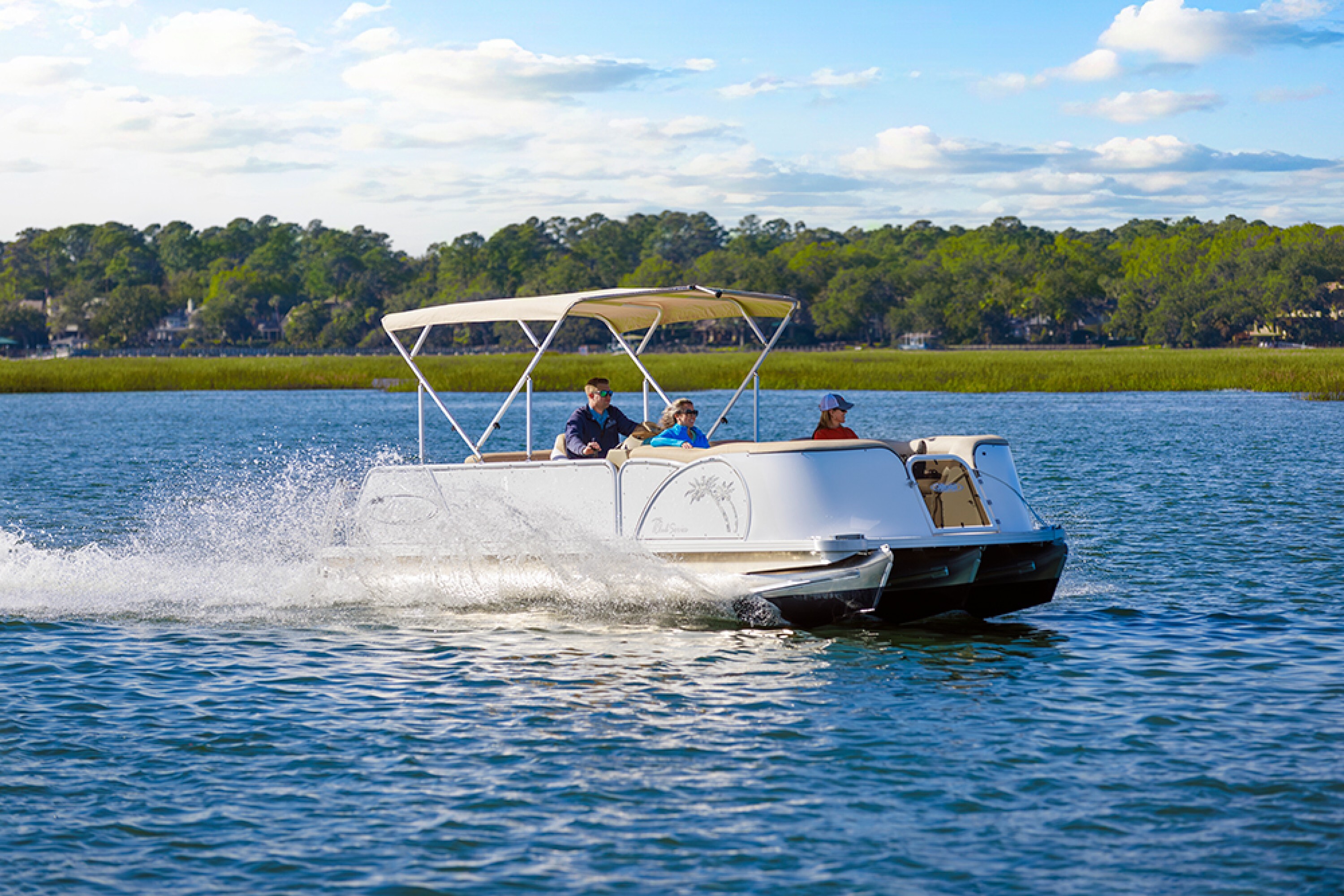 pontoon boat with bimini driving in the water