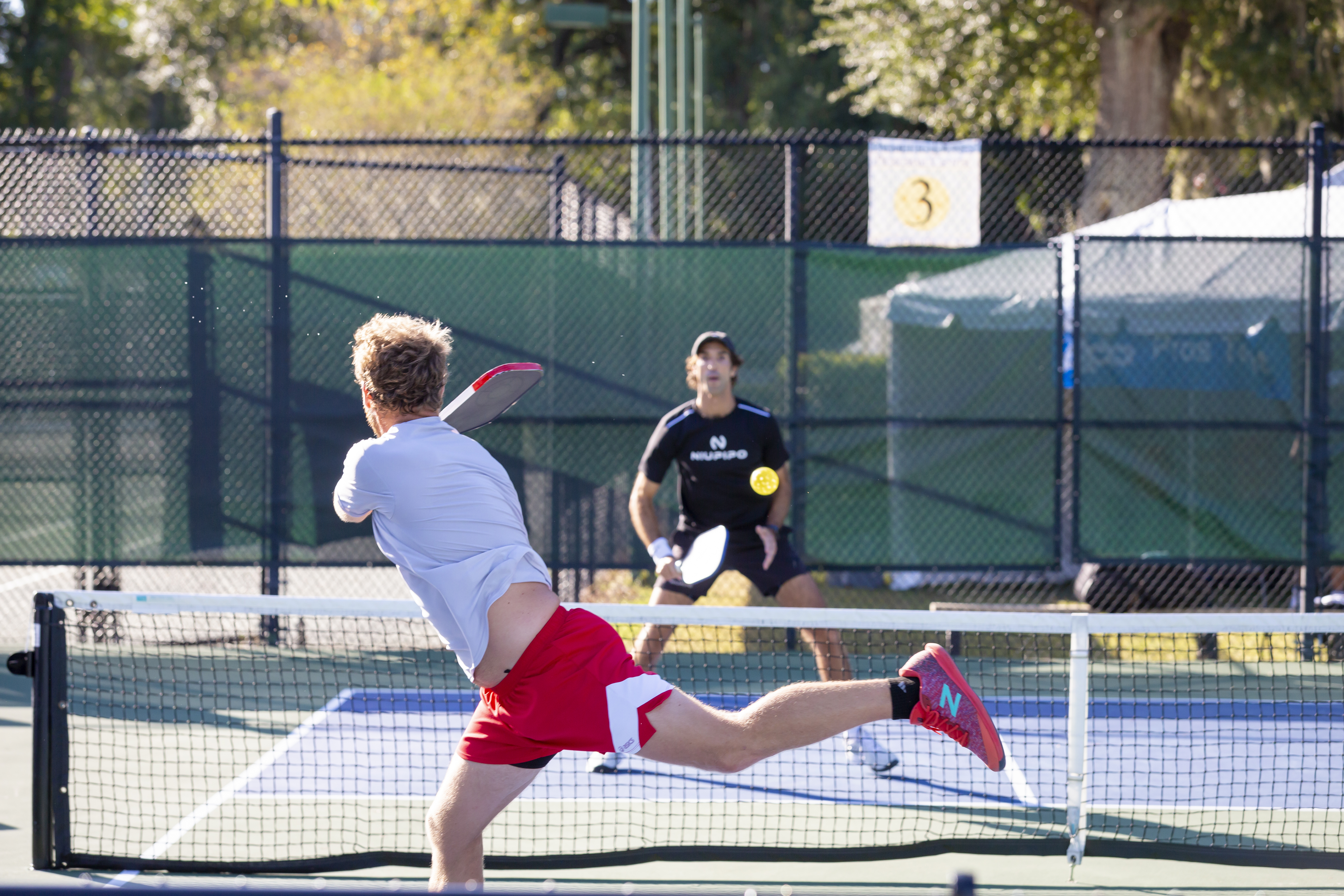 pickleball players in action on court