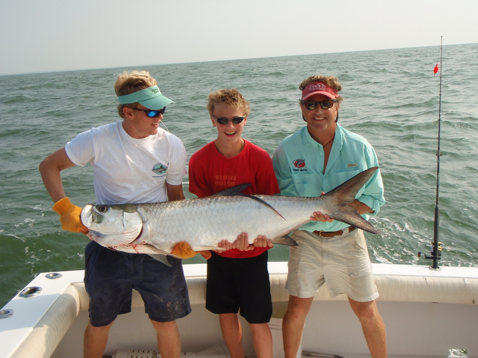 Three men with fish