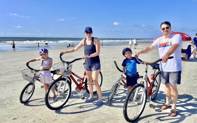 Family biking on beach
