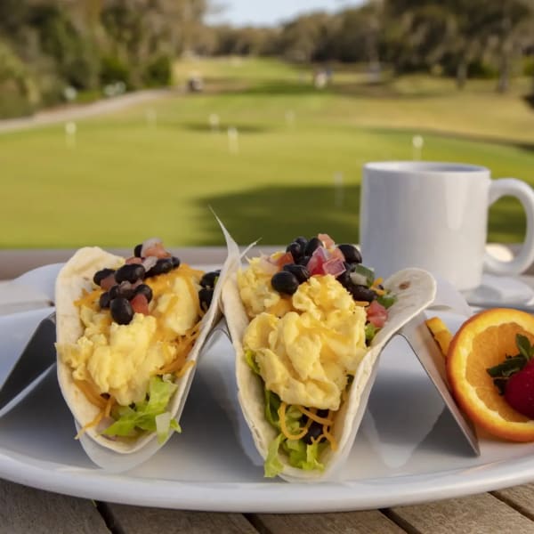 Breakfast tacos and fruit with a coffee overlooking the golf course at Big Jim's