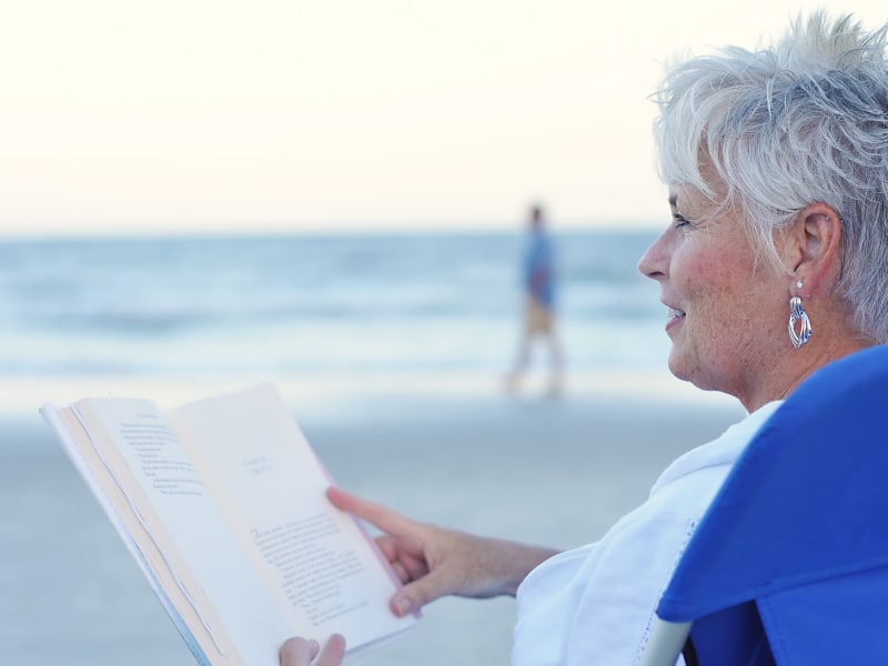 Lady reading book on beach