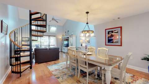 Dining room with spiral staircase at Captain's Cove