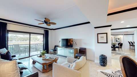 Living room with access to a balcony at Captain's Quarters