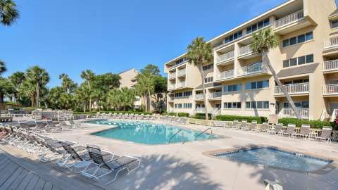 Community pool with buildings in the background at Captain's Walk
