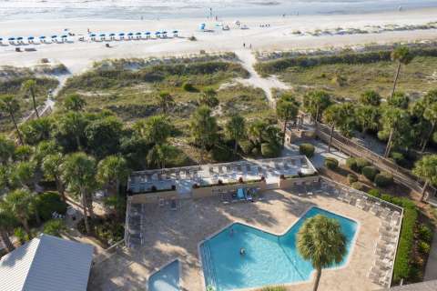 Aerial view of community pool with beach access at Captain's Walk