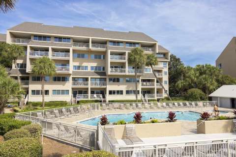Community pool with building in the background at Captain's Walk