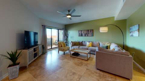 Living room with access to the patio in a villa at Harbourside
