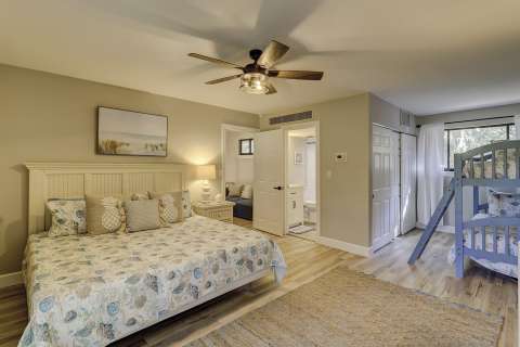Primary bedroom with a king bed and bunk beds at Hickory Cove