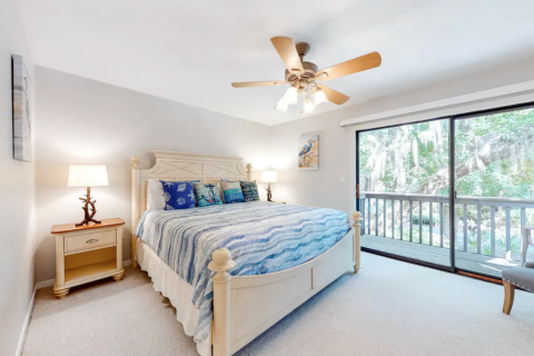Primary bedroom with access to a balcony at Hickory Cove