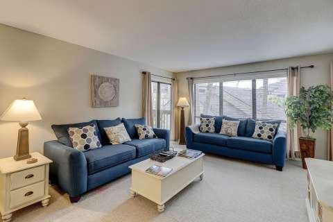 Updated living room with access to the balcony at The Moorings