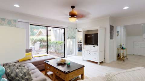 Living room with a door to the Patio in a villa at Water Oak